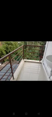 a view of a balcony with a sink and a fence at Aswathy Bhavan in Palakkad