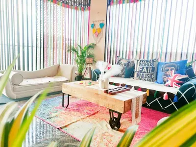 a living room with two couches and a coffee table at Tranquil Traditions Homestay - Inspired by Nature & Heritage in Mysore