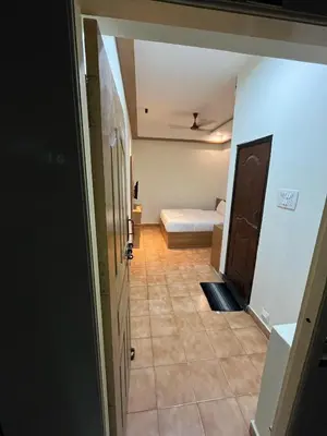 a hallway with a room with a bed and a door at City Centre in Coimbatore