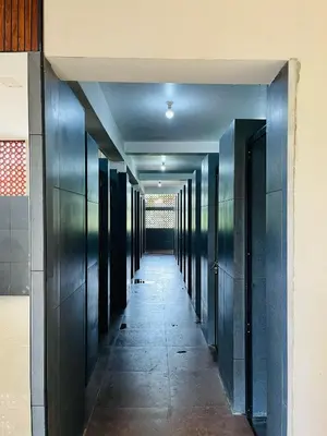 a hallway in a building with black doors at City Centre in Coimbatore