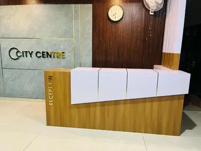 a clock on a wall next to a box at City Centre in Coimbatore