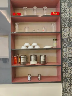 a shelf with dishes and jars on it at G3 nest in Mysore