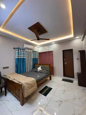 a bedroom with a bed and a ceiling at G3 nest in Mysore