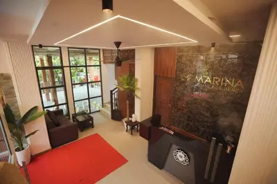 an aerial view of a living room with a red rug at Hotel Le Marina Residency in Kozhikode