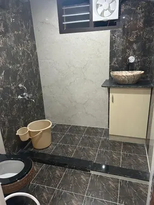 a bathroom with a toilet and a sink at Franklin's Finestay in Kotagiri