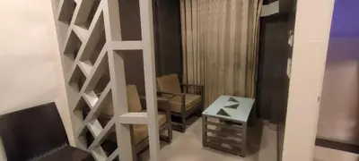 a room with a partition with a chair and a table at Cocoa Tree Munnar in Munnar