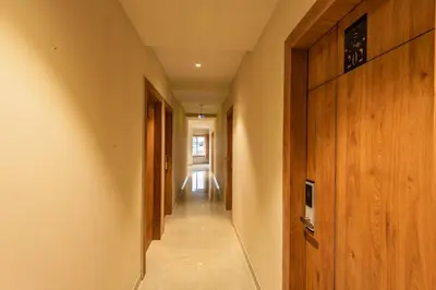 a long hallway with wooden walls and a hallway at Hotel Beverly Palace Kozhikode - Hotel and Restaurant in Kozhikode
