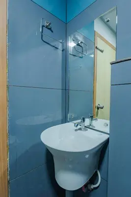 a bathroom with a sink and a glass shower at Hotel Beverly Palace Kozhikode - Hotel and Restaurant in Kozhikode
