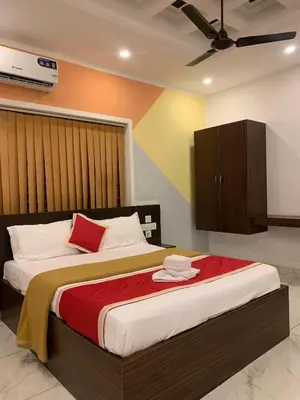 a bedroom with a large bed in a room at Adi Deva Inn in Guruvāyūr