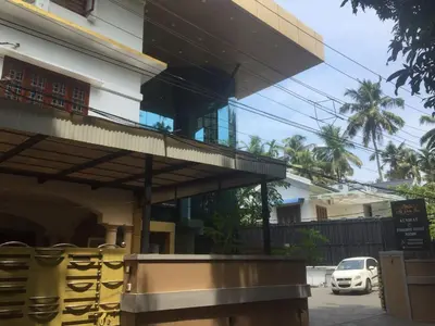 a building with a balcony on the side of it at Adi Deva Inn in Guruvāyūr