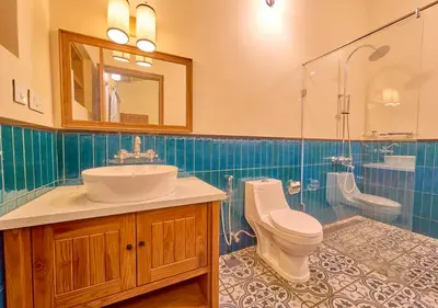 a bathroom with a sink and a toilet and a shower at Mowbray House Resort Ooty by VOYE HOMES in Ooty