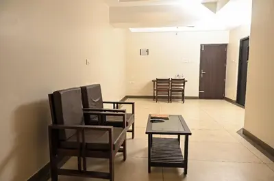 a room with chairs and a table and a dining room at Guruvayoor Suits Pankaj Suits in Trichūr