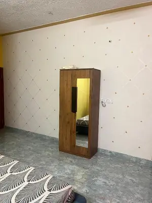 a mirror in a room with a bed in it at Chamundi Temple-Hill View in Mysore