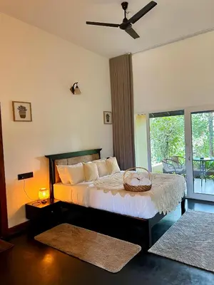 a bedroom with a bed with a basket on it at Tangerine Tales Boutique Resort By LexStays in Wayanad