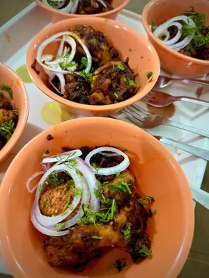 a bowl of food with onions on a table at Anya Retreats Nature Homestay in Kushālnagar