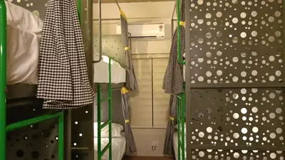 a room with a shower and a wall with polka dots at Zostay Urban Retreat Deluxe Rooms & Premium Dorms in Manjeri