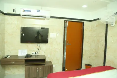 a room with a tv on a wall at S M Residency in Tiruppūr