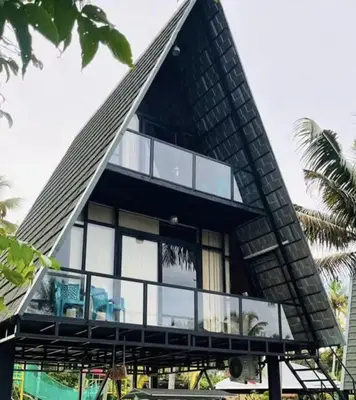 a modern house with a triangular roof at Parlak in Karuvapadna