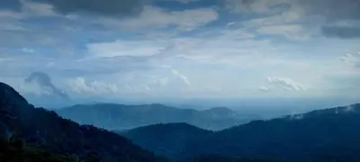 a view of a mountain valley with trees and clouds at Mamalakandam - Egg House - in Diya Homestay in Mamalakandam