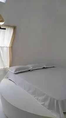 a white bed with a sheet on top of it at Mamalakandam - Egg House - in Diya Homestay in Mamalakandam