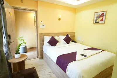 a bedroom with two beds in a room at M M Hotel Royal Respite in Coimbatore