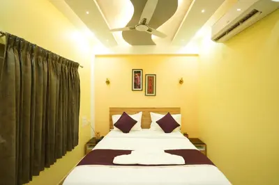 a bedroom with a large bed with purple pillows at M M Hotel Royal Respite in Coimbatore