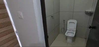 a small bathroom with a toilet in a stall at Smile Residency in Sultan Bathery