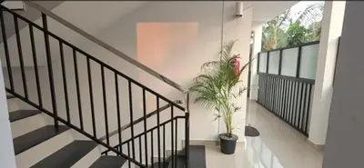 a staircase with a plant in a house at Smile Residency in Sultan Bathery