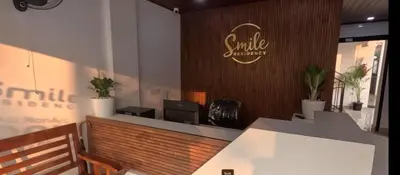 a smile office with a bench and plants at Smile Residency in Sultan Bathery