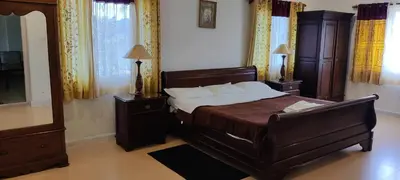 a bedroom with a large bed and a mirror at Mountain Top Holiday Home in Ooty