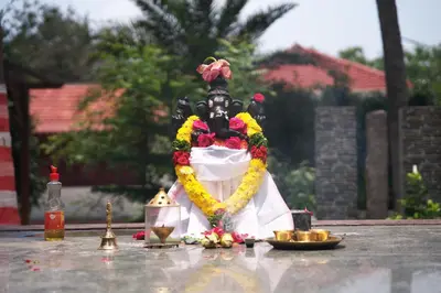 a figurine of a person with a skull on a table at Metro Club Resort in Kāmānayakkanpālaiyam