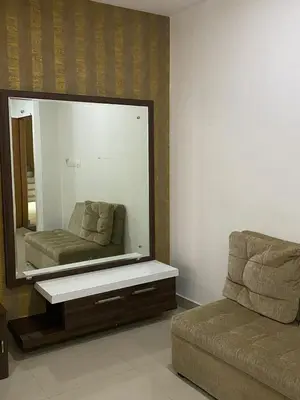 a living room with a large mirror and a couch at Pumpkin Tower in Malappuram