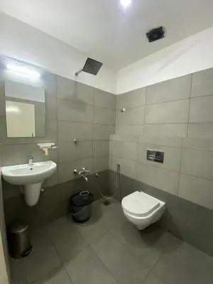 a bathroom with a toilet and a sink at Pumpkin Tower in Malappuram