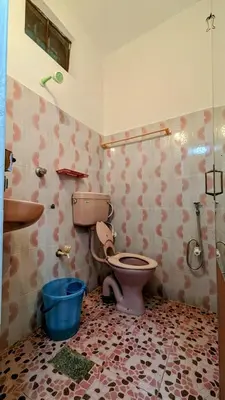 a bathroom with a toilet and a sink at Spacious 2-storey home-4 bedroom in Kunnamkulam