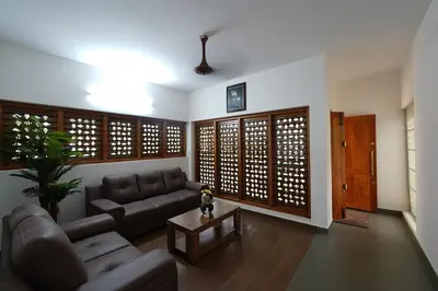 a living room with a couch and a table at Verdant Courtyard, 3BHK, Near IIM, NITC in Kozhikode