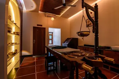 a kitchen with a island in a room at Dr Indulekhas Ayurvedic Wellness And Rejuvenation in Tellicherry