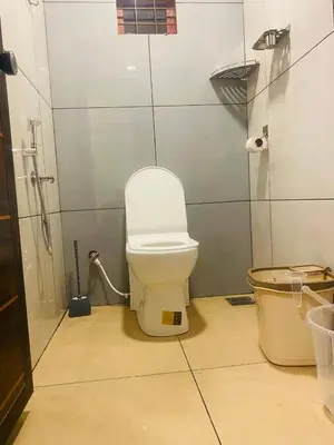 a bathroom with a white toilet and a shower at JoeVilla Homestay Near Kottiyoor in Kelakam