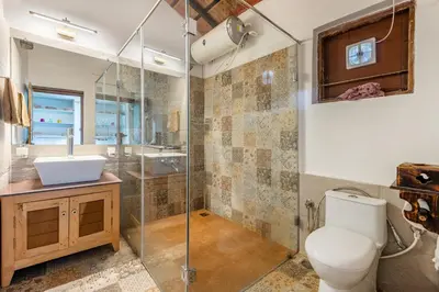a bathroom with a toilet and a sink and a shower at Sliceinn Somewhere Together In Biligeri in Madikeri