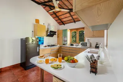 a kitchen with a counter with fruit on it at Sliceinn Somewhere Together In Biligeri in Madikeri