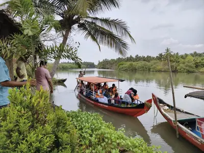 a group of people on a boat on a river at Kadingis homestay and eco tourism in Kadalundi