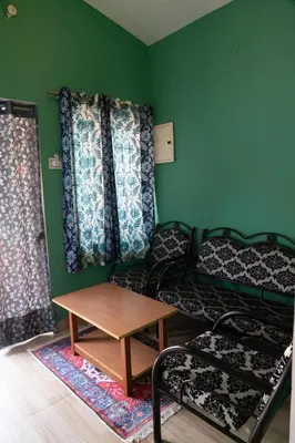 a room with two bunk beds and a table at Retro Radiance in Ooty