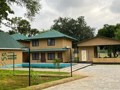 a house with a pool in front of it at Ibex Resorts, Malampuzha - Kava Eco Camp and Caravan Park in Palakkad