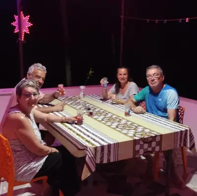 a group of people sitting around a table playing chess at Peaceful Homestay near Kizhunna Beach in Thottada