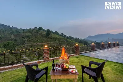 a table with food on it with chairs and a fire at StayVista at Ambrosia access to water stream in Kotagiri