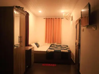 a small bedroom with a bed and a window at Fogland Villa in Vaduvanchal