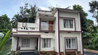 a white house with a balcony at Vintage Coffee Premium Villa in Pinangode