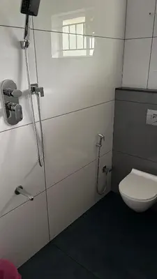 a bathroom with a toilet and a shower at Vintage Coffee Premium Villa in Pinangode