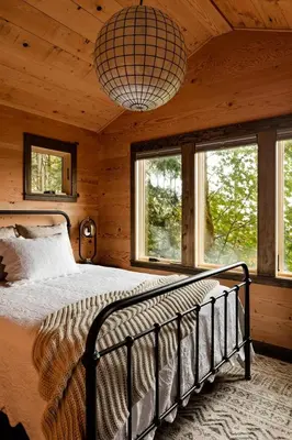 a bedroom with a bed in a room with windows at Vanilla Farms in Koroth