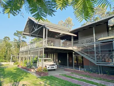 a house with a car parked in front of it at Hidden Haven 1BR Coorg in Kushālnagar