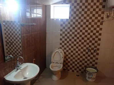 a bathroom with a toilet and a sink at Hills Dale ooty 3 bhk vintage tea estate villa in Ooty